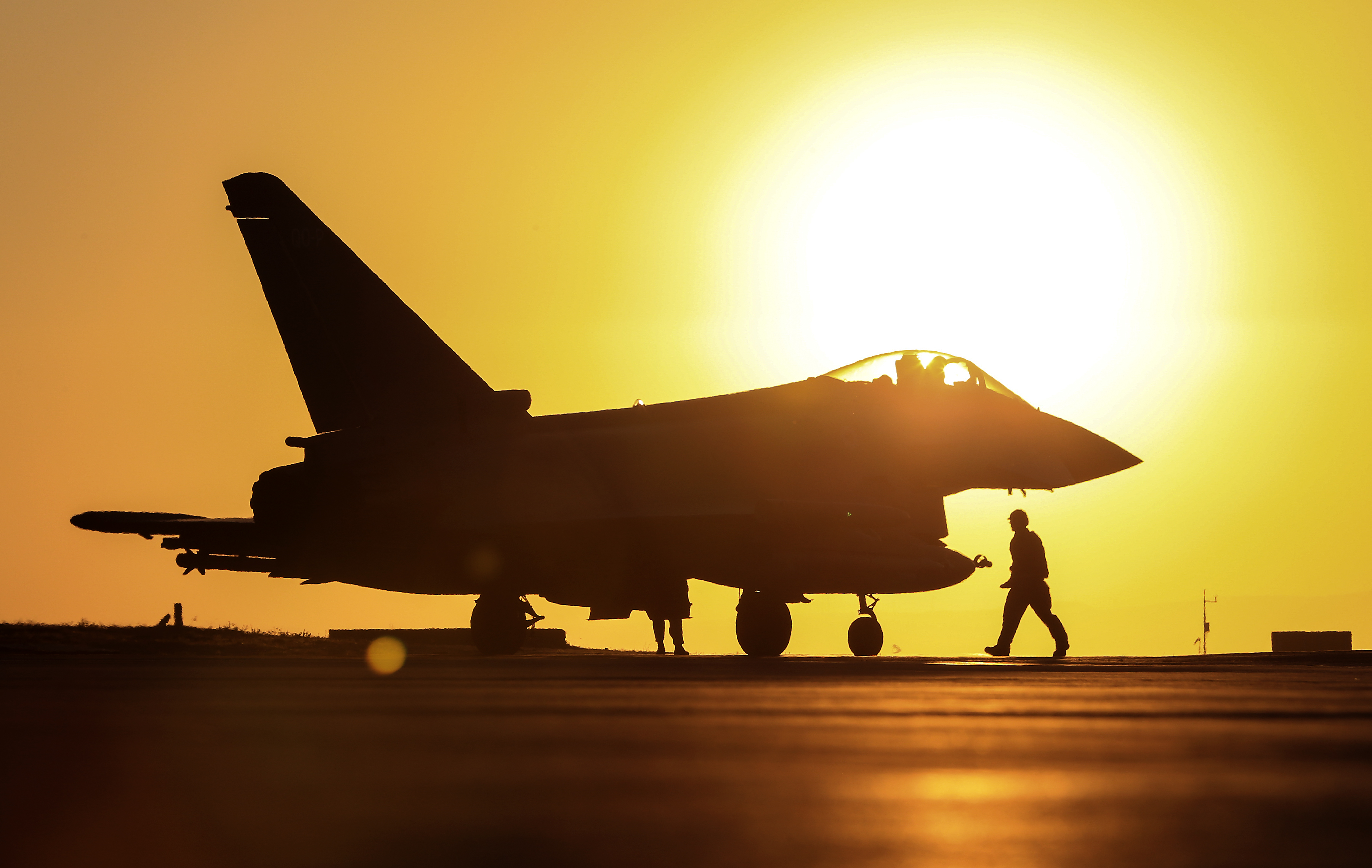 Image shows RAF Typhoon and pilot in sunset.